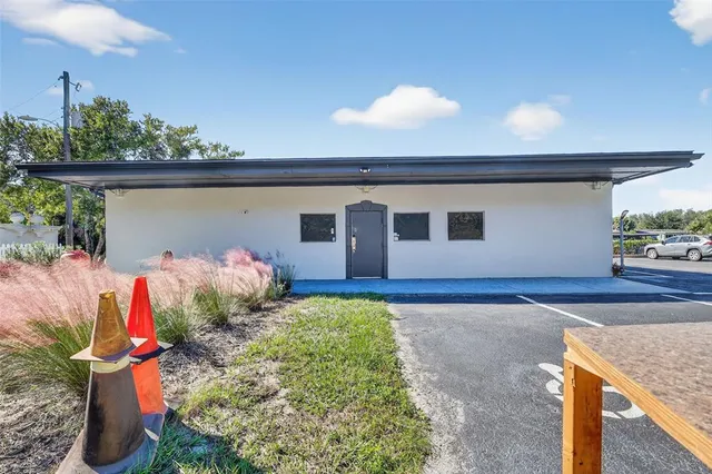 a front view of a house with lots of potted plants