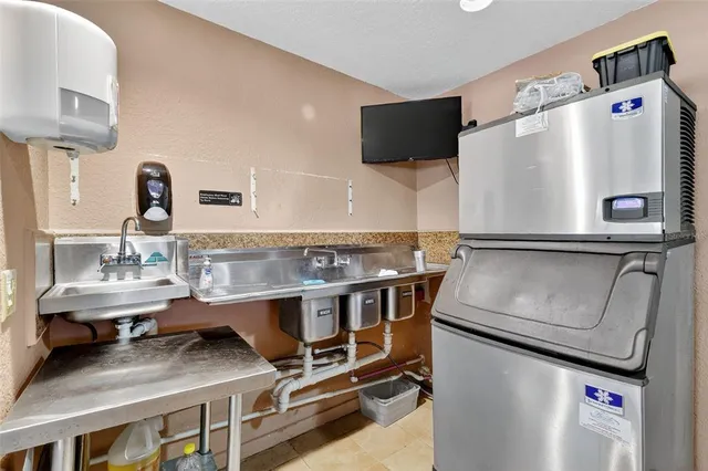 a kitchen with refrigerator and stove