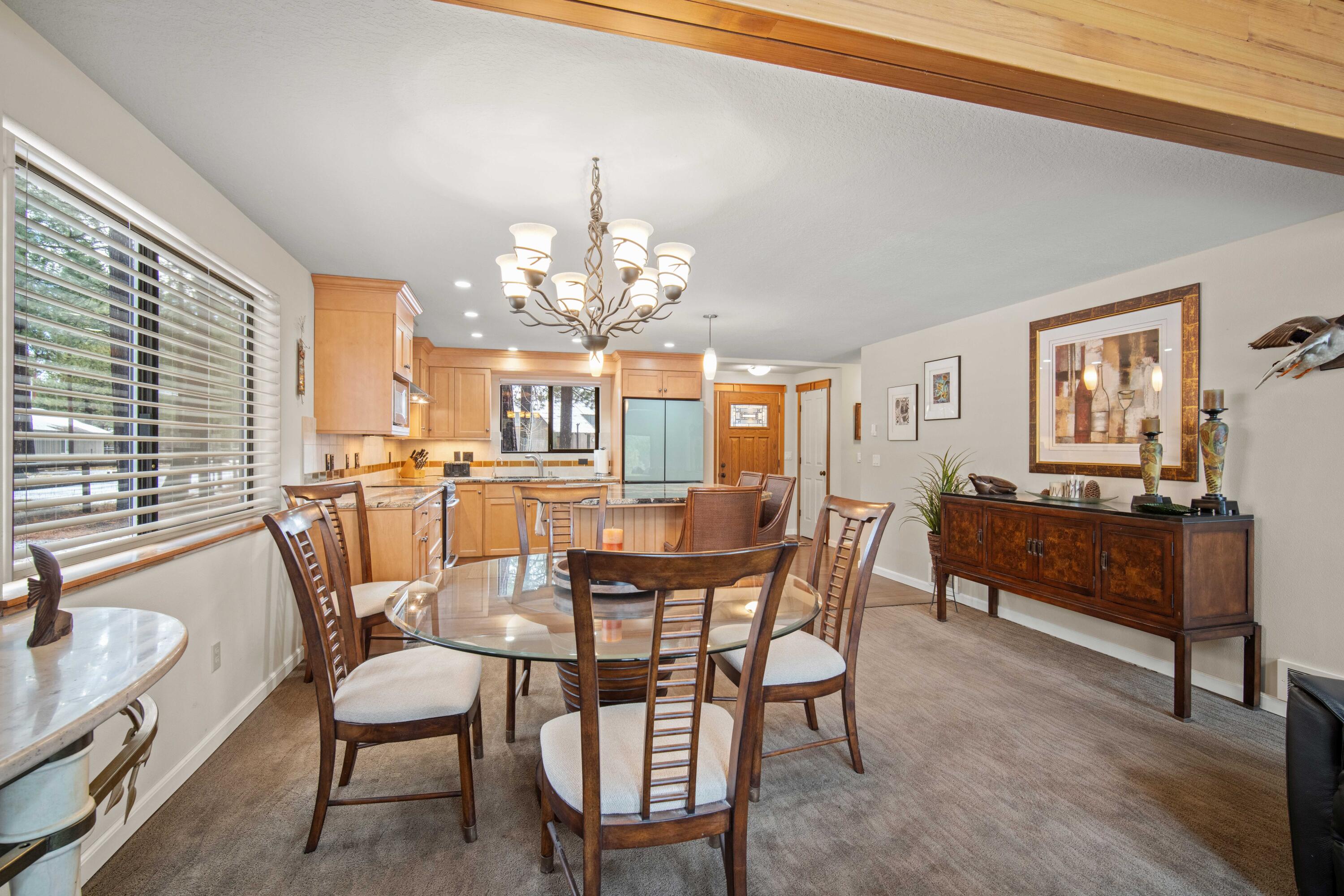 56019 Snow Goose Road Bend, OR 97707 - Photo 17 of 32 a view of a dining room with furniture and chandelier