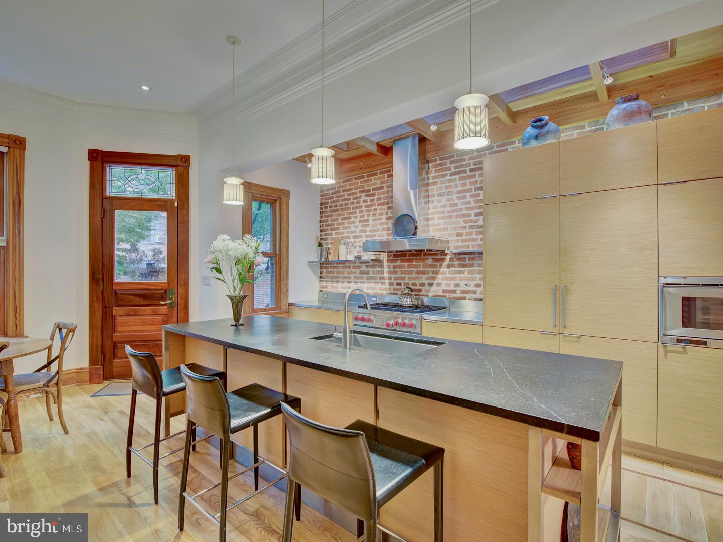 1705 Q Street Northwest Washington, DC 20009 - Photo 20 of 87 a kitchen with a table chairs sink and cabinets