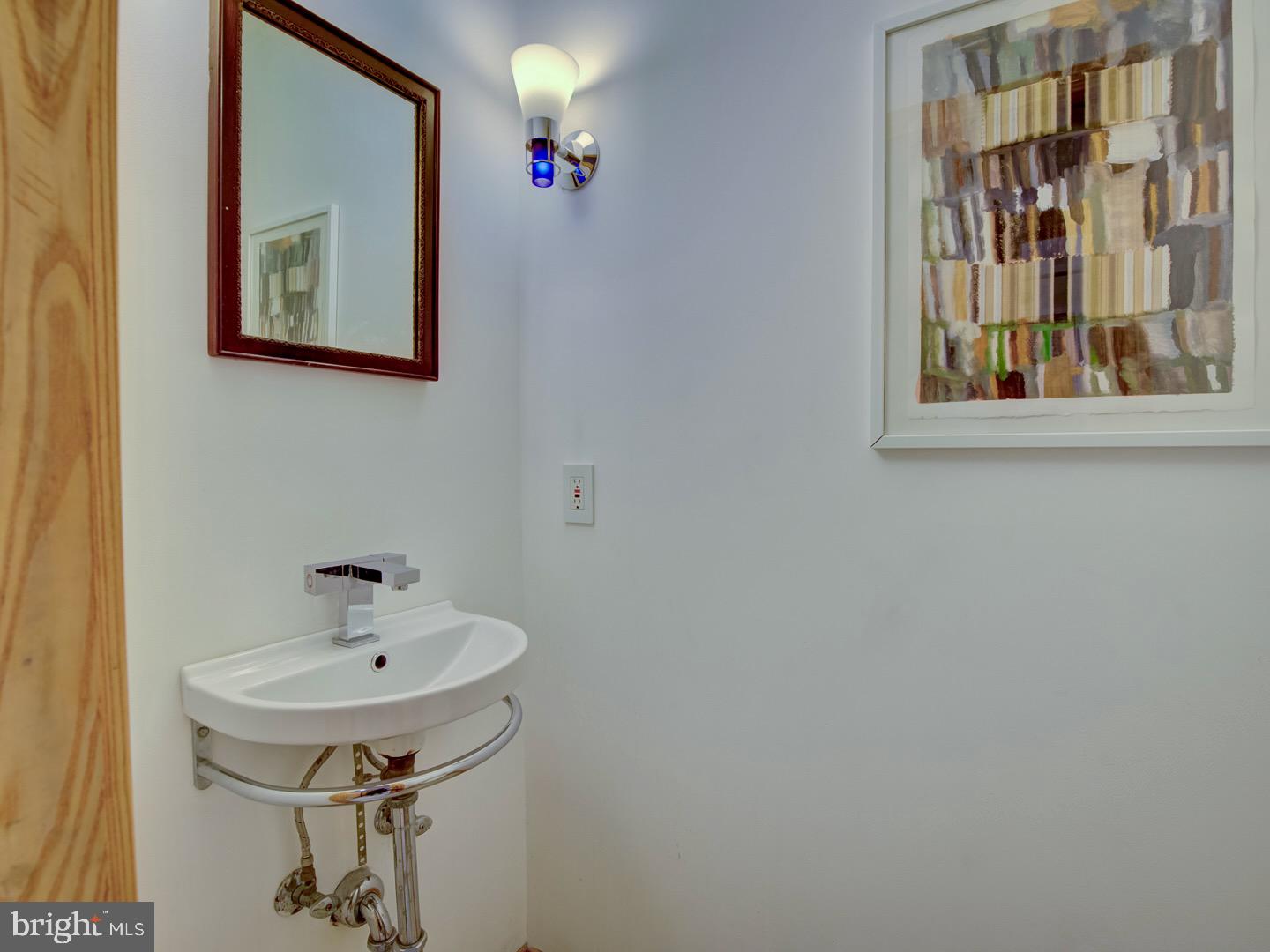 1705 Q Street Northwest Washington, DC 20009 - Photo 81 of 87 a bathroom with a sink and a mirror