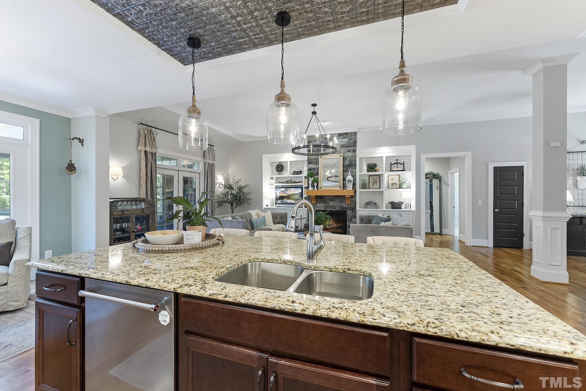 6121 Spring Branch Circle Raleigh, NC 27603 - Photo 14 of 60 a view of a kitchen with kitchen island granite countertop a sink and dishwasher with granite countertop cabinets