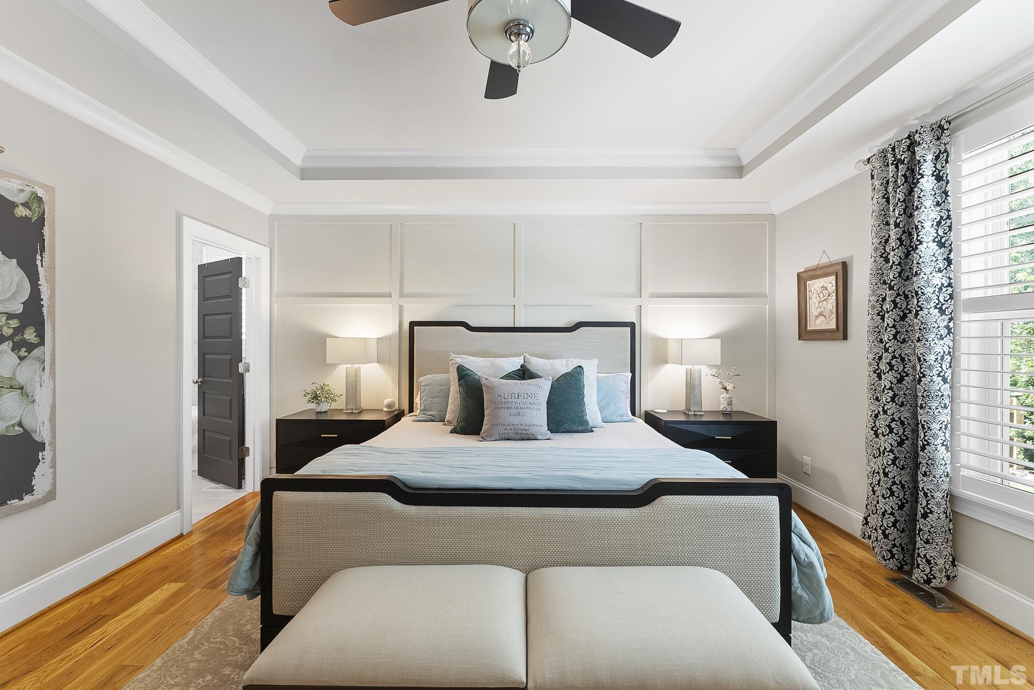 6121 Spring Branch Circle Raleigh, NC 27603 - Photo 17 of 60 a bedroom with a large bed and a chandelier