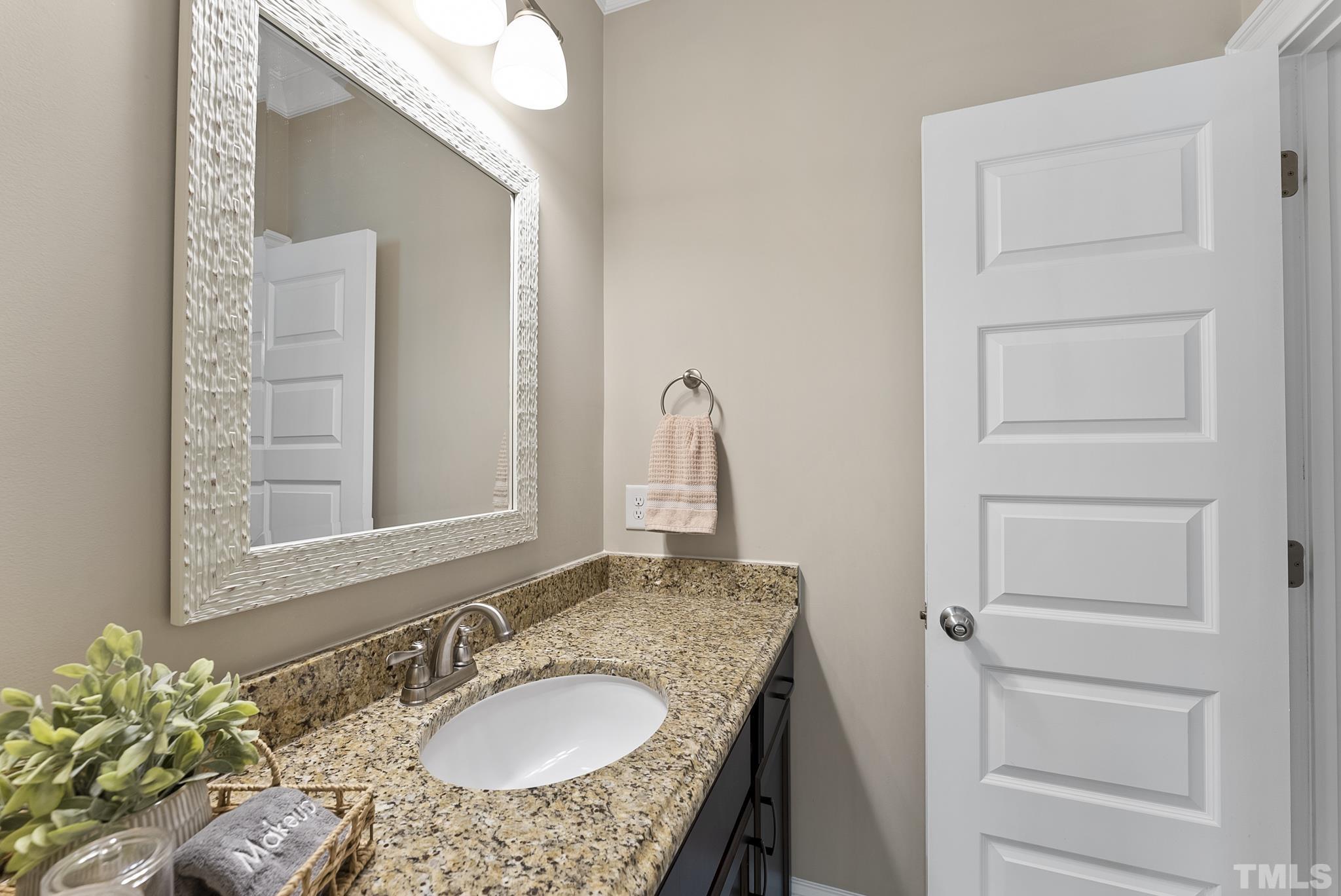6121 Spring Branch Circle Raleigh, NC 27603 - Photo 22 of 60 a bathroom with a granite countertop sink and a mirror