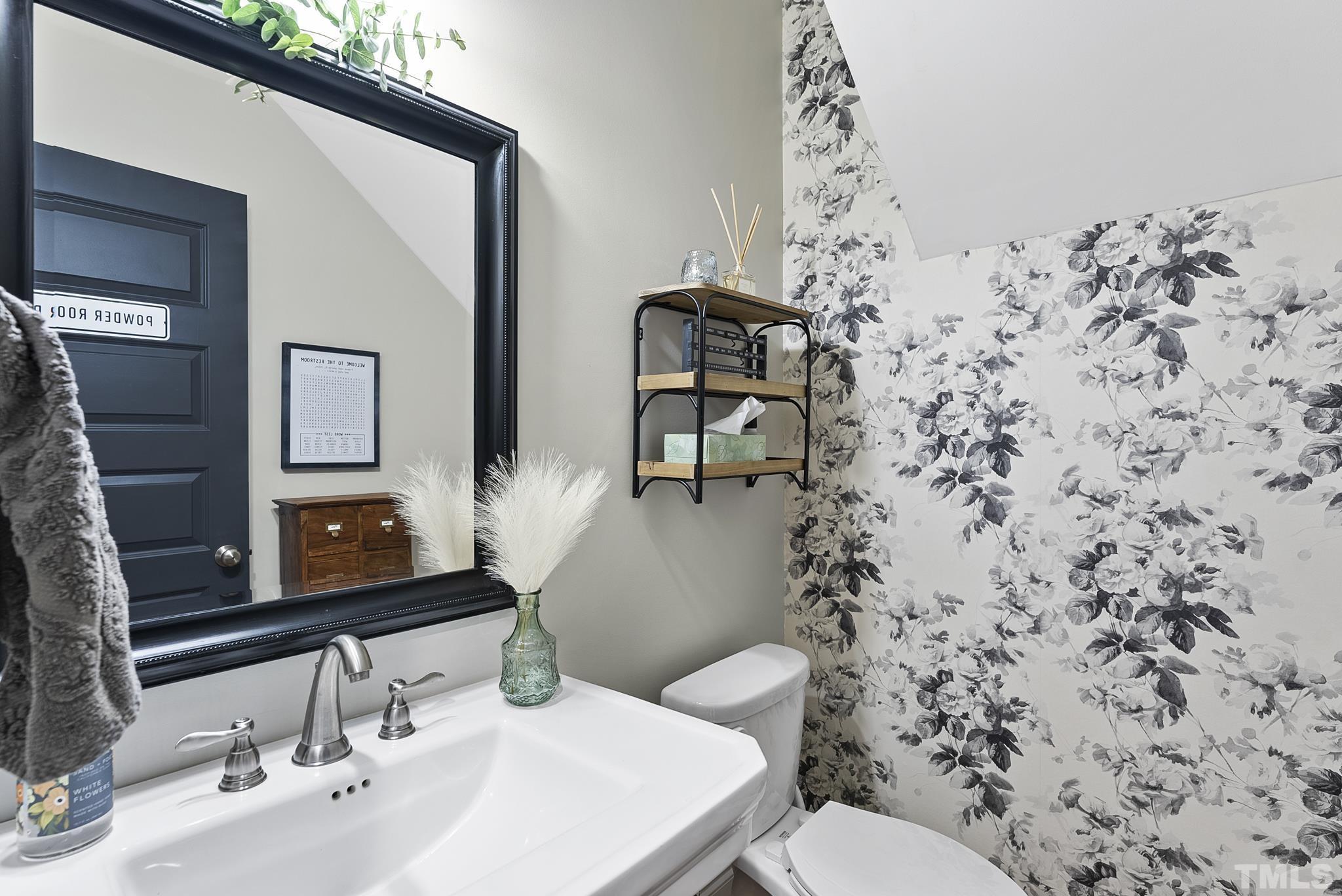 6121 Spring Branch Circle Raleigh, NC 27603 - Photo 26 of 60 a bathroom with a toilet sink and mirror