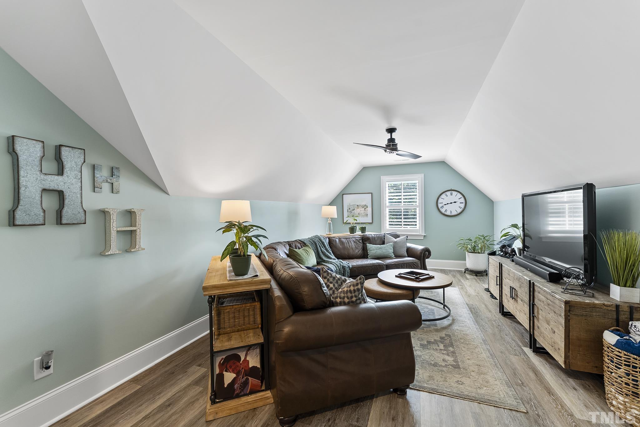6121 Spring Branch Circle Raleigh, NC 27603 - Photo 30 of 60 a living room with furniture and a flat screen tv