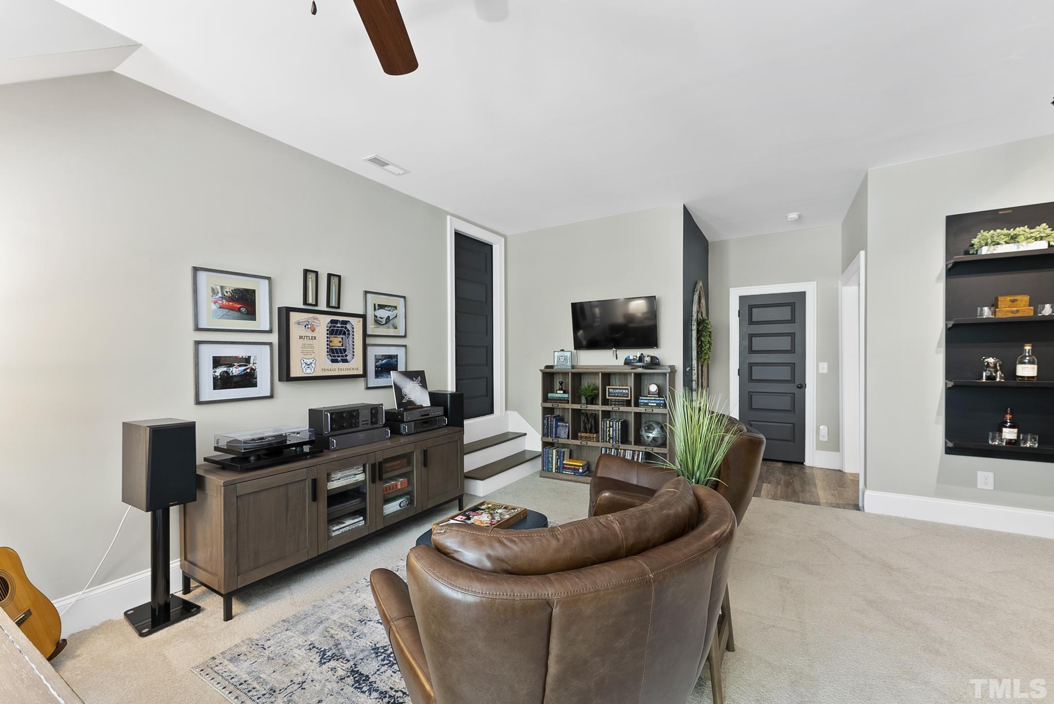 6121 Spring Branch Circle Raleigh, NC 27603 - Photo 35 of 60 a living room with furniture and a flat screen tv