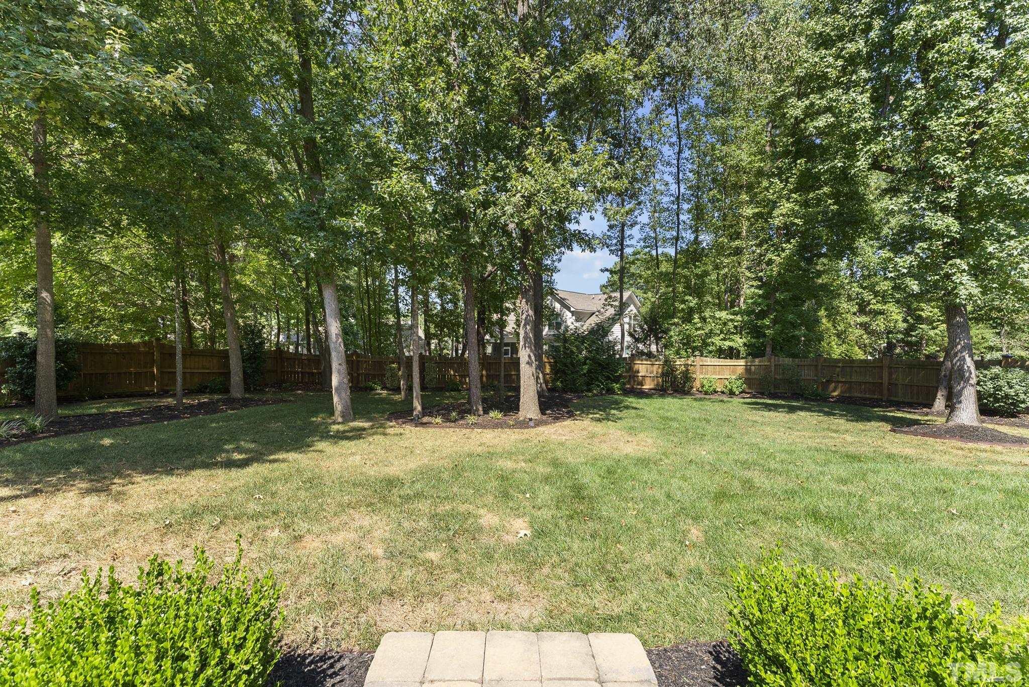 6121 Spring Branch Circle Raleigh, NC 27603 - Photo 46 of 60 a backyard of a house with trees and entertaining space