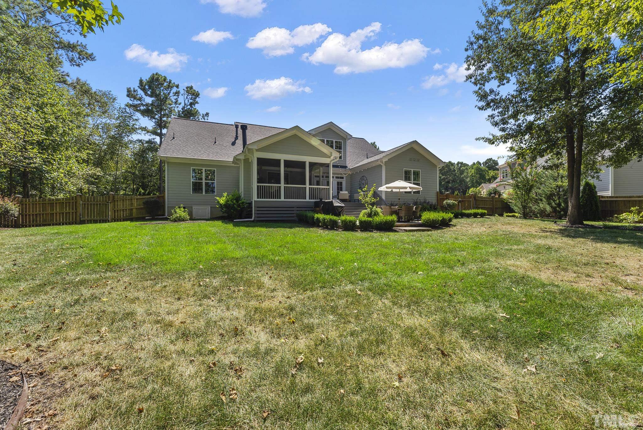 6121 Spring Branch Circle Raleigh, NC 27603 - Photo 48 of 60 a front view of a house with a garden and trees