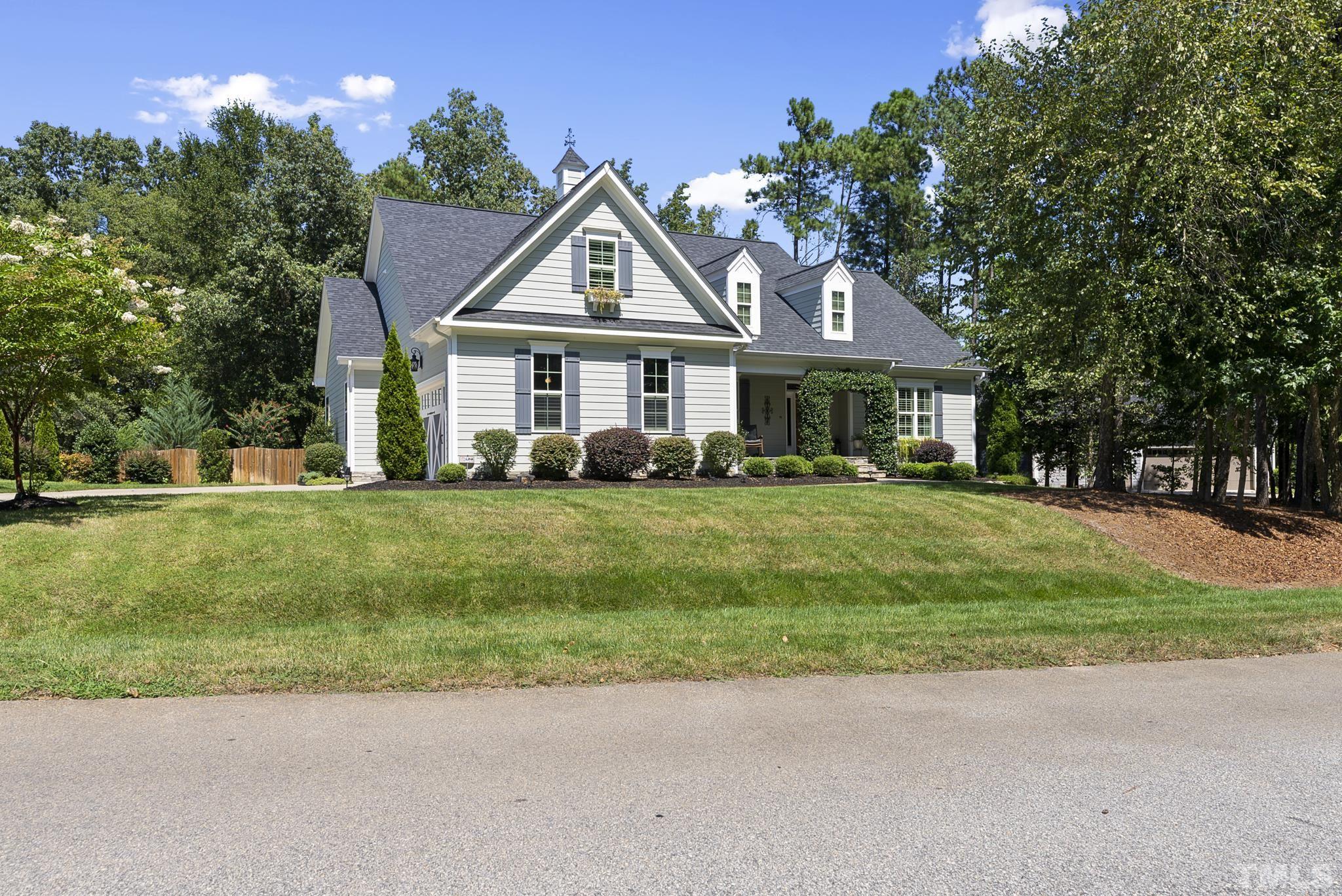 6121 Spring Branch Circle Raleigh, NC 27603 - Photo 56 of 60 a front view of a house with a garden