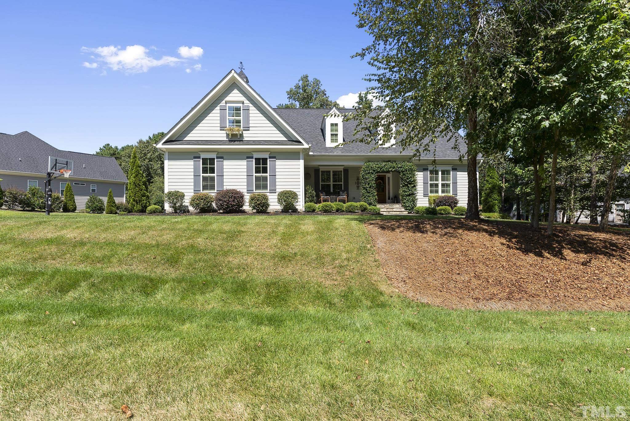 6121 Spring Branch Circle Raleigh, NC 27603 - Photo 57 of 60 a front view of a house with a yard and trees
