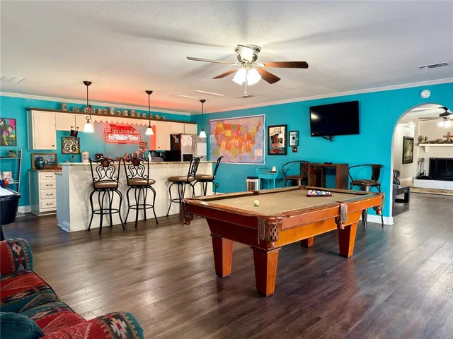 a bedroom with furniture and a flat screen tv
