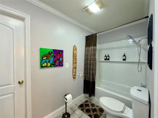 a bathroom with a toilet a sink and shower