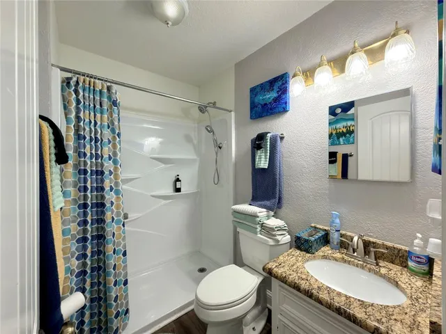 a view of a city street with lots of cars parked on the road