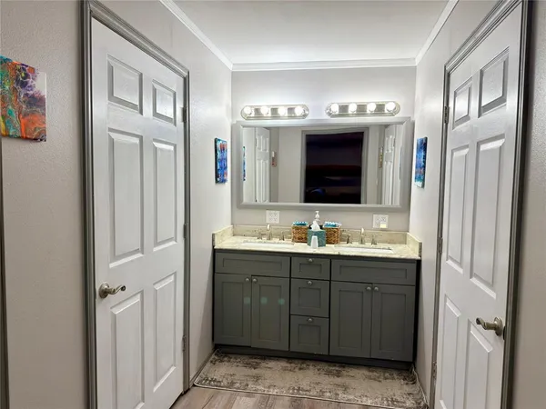 a bathroom with a double vanity sink and a mirror