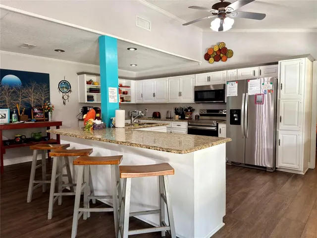 a large bathroom with a granite countertop double vanity sink a mirror and a shower