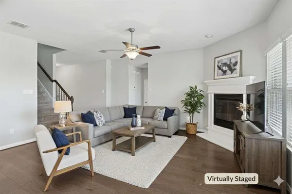 a living room with furniture potted plant and a fireplace