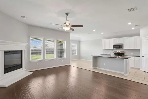 a kitchen with a sink a microwave a stove and refrigerator