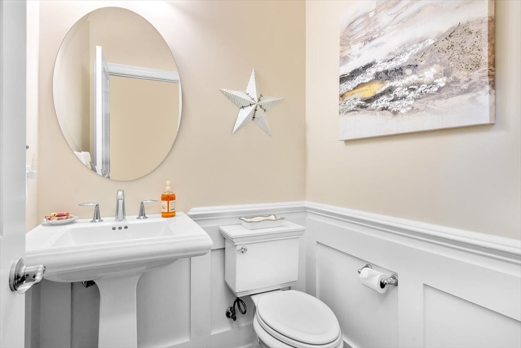 5 Brand Boulevard, Unit 5 Scituate, MA 02066 - Photo 14 of 42 a bathroom with a sink mirror and toilet