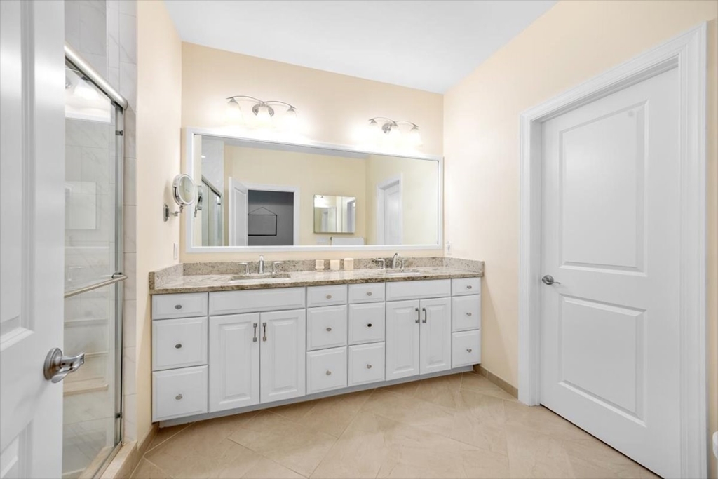 5 Brand Boulevard, Unit 5 Scituate, MA 02066 - Photo 18 of 42 a bathroom with a granite countertop double vanity sink a mirror and a