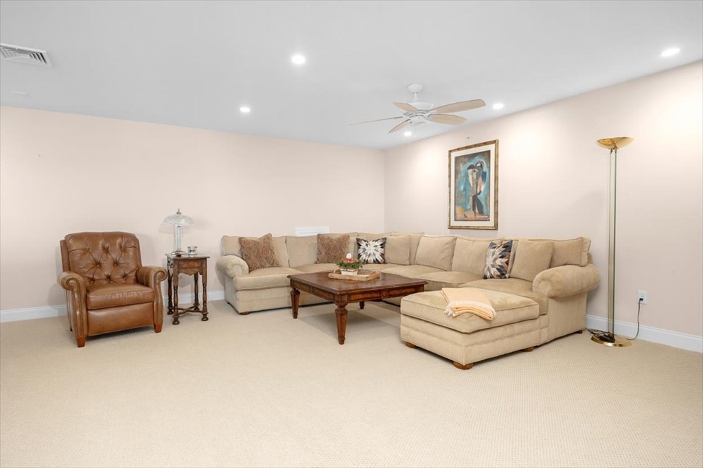 5 Brand Boulevard, Unit 5 Scituate, MA 02066 - Photo 22 of 42 a living room with furniture and white walls