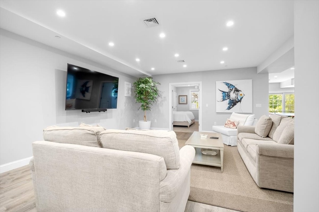 5 Brand Boulevard, Unit 5 Scituate, MA 02066 - Photo 25 of 42 a living room with furniture and a flat screen tv