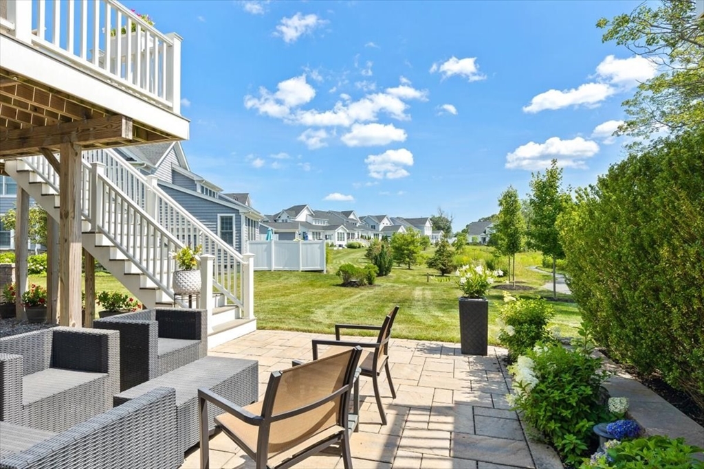 5 Brand Boulevard, Unit 5 Scituate, MA 02066 - Photo 30 of 42 a view of a patio with couches table and chairs and potted plants