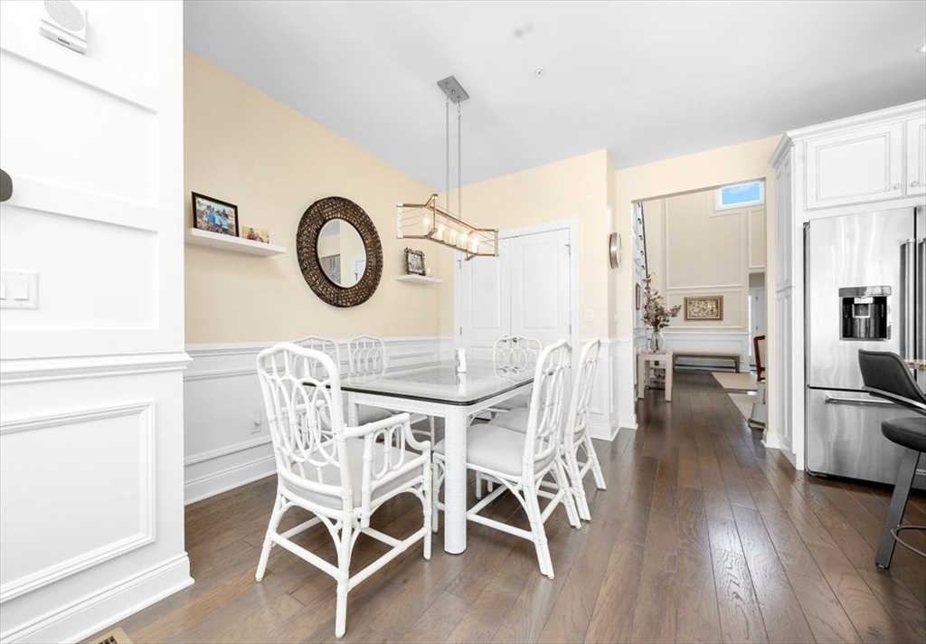 5 Brand Boulevard, Unit 5 Scituate, MA 02066 - Photo 7 of 42 a view of a dining room with furniture wooden floor and a chandelier