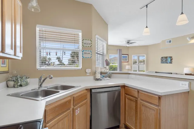 a kitchen with stainless steel appliances a sink a stove and a refrigerator