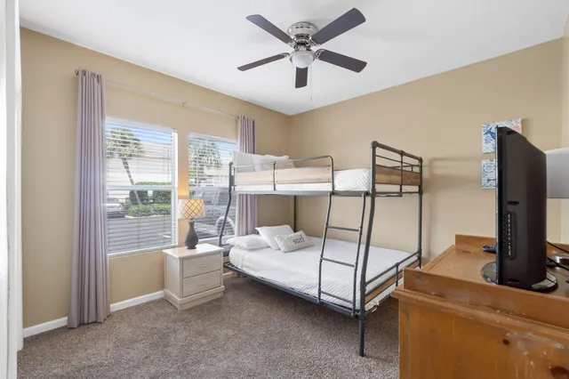 a bedroom with a bed and large window