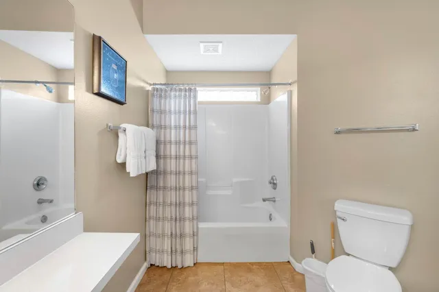 a bathroom with a toilet and bathtub