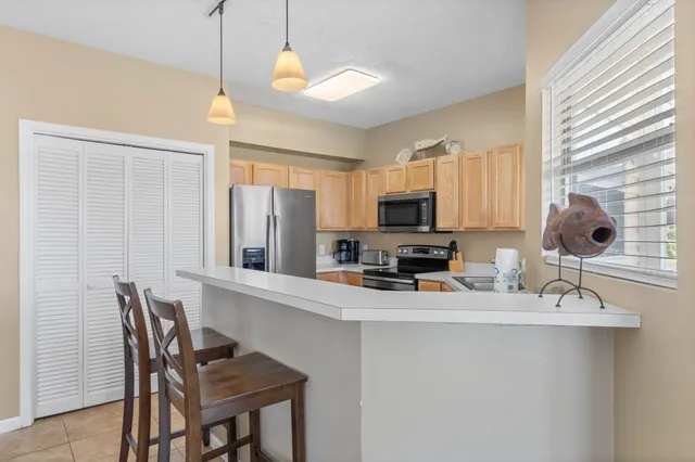 a kitchen with stainless steel appliances a sink stove and refrigerator