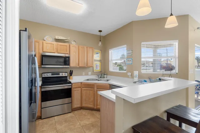 a kitchen with a sink stove top oven and refrigerator