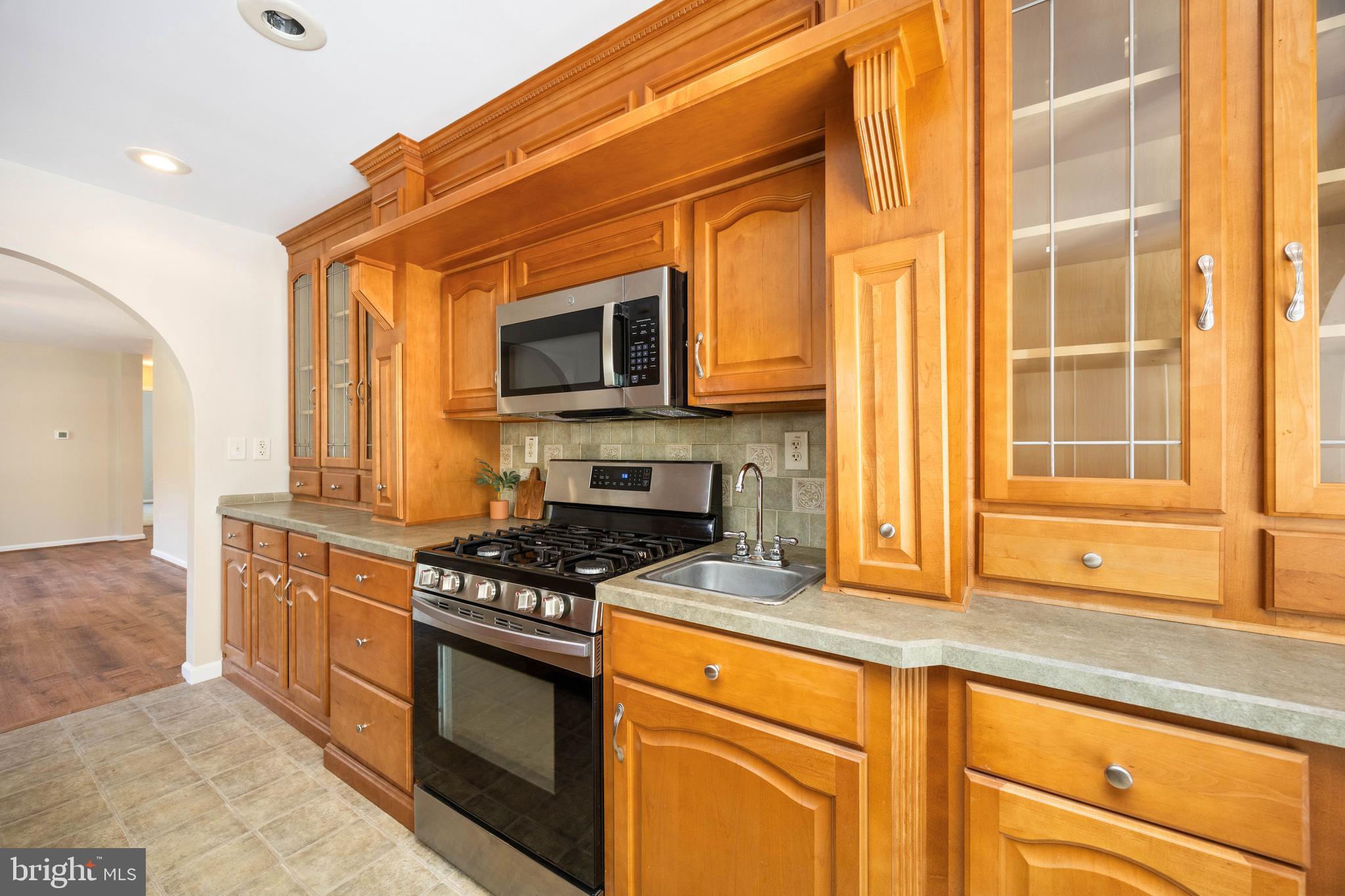 6635 Libertytown Road Berlin, MD 21811 - Photo 19 of 88 a kitchen with stainless steel appliances granite countertop a stove a sink and a microwave