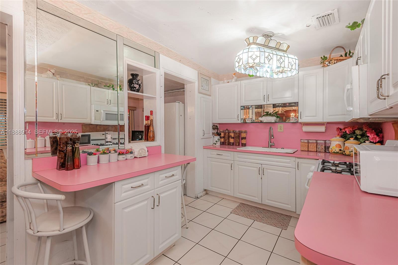 1083 Northwest 74th Street Miami, FL 33150 - Photo 11 of 28 a kitchen with a sink stove and cabinets
