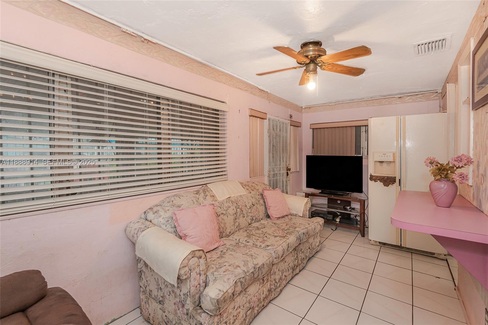 1083 Northwest 74th Street Miami, FL 33150 - Photo 14 of 28 a living room with furniture and a flat screen tv