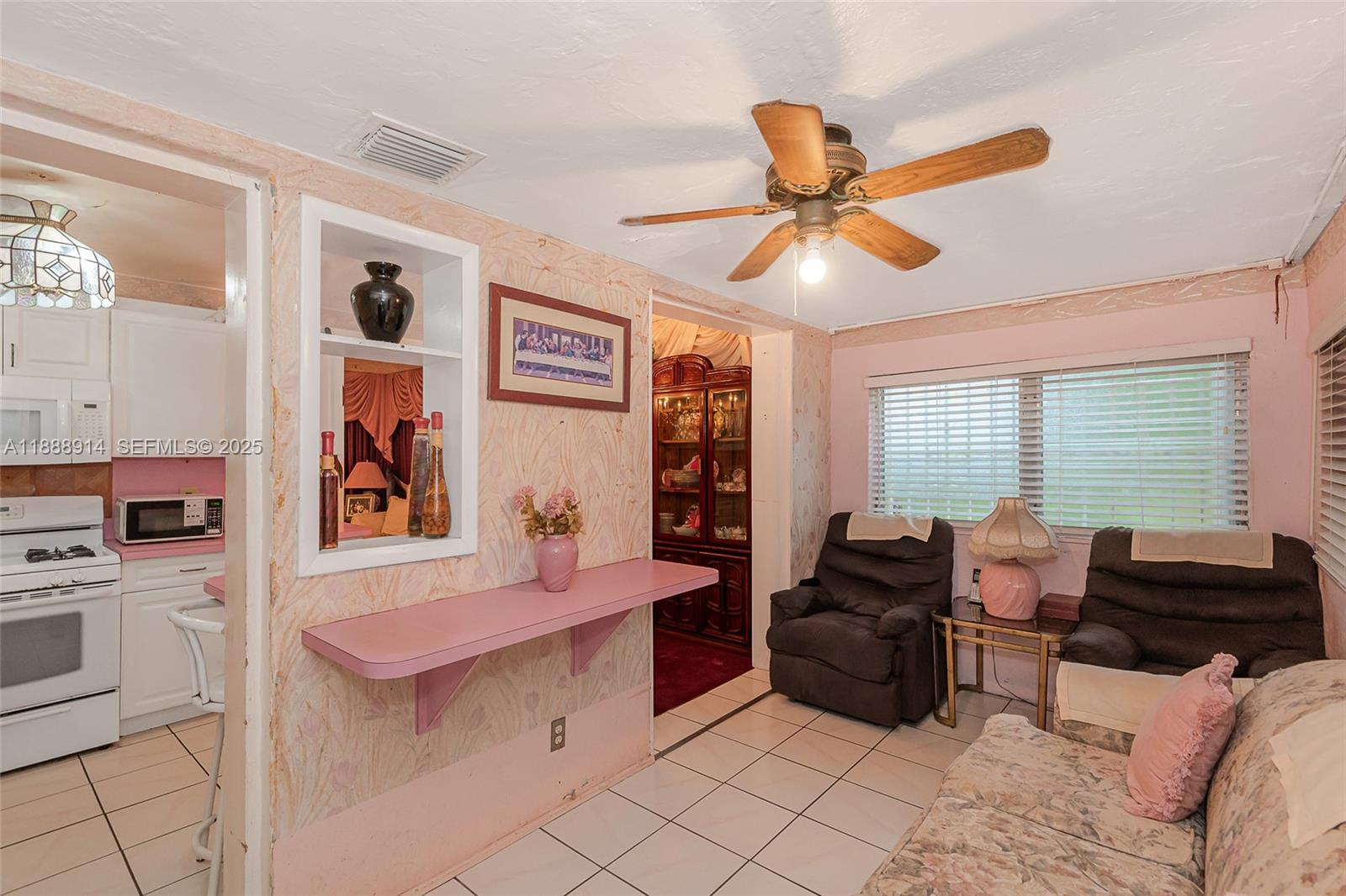 1083 Northwest 74th Street Miami, FL 33150 - Photo 16 of 28 a living room with furniture ceiling fan and a window