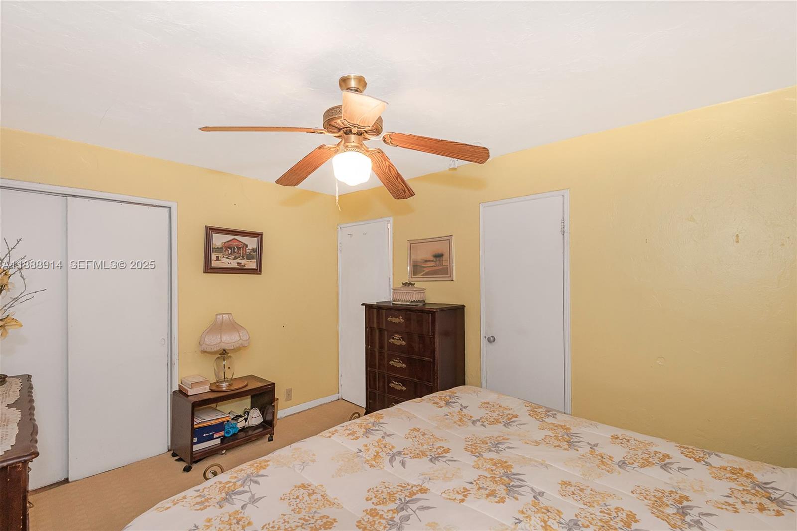 1083 Northwest 74th Street Miami, FL 33150 - Photo 19 of 28 a bedroom with a bed and a chandelier