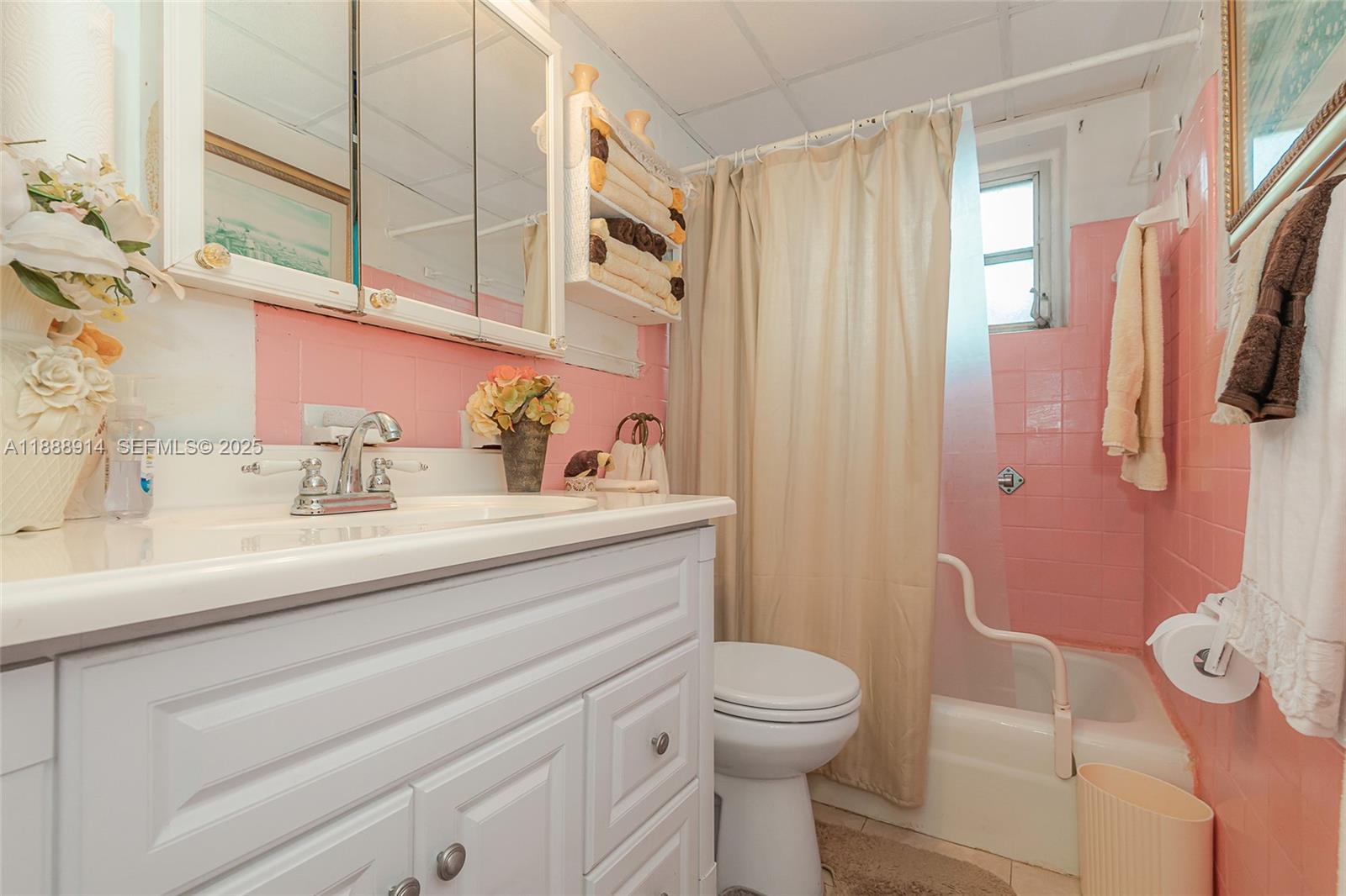 1083 Northwest 74th Street Miami, FL 33150 - Photo 20 of 28 a bathroom with a sink a toilet a mirror and shower