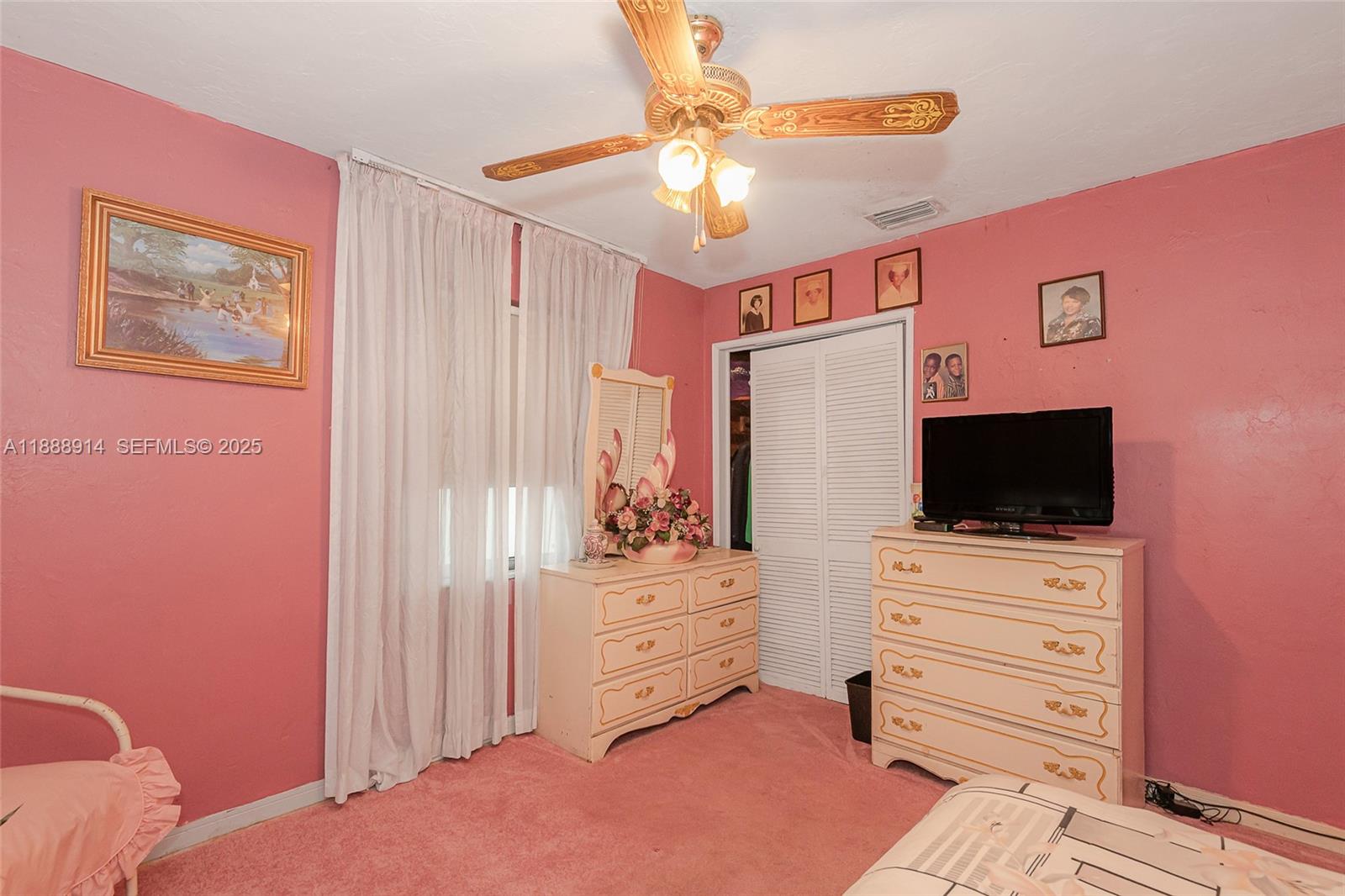 1083 Northwest 74th Street Miami, FL 33150 - Photo 22 of 28 a view of bedroom with furniture and flat screen tv