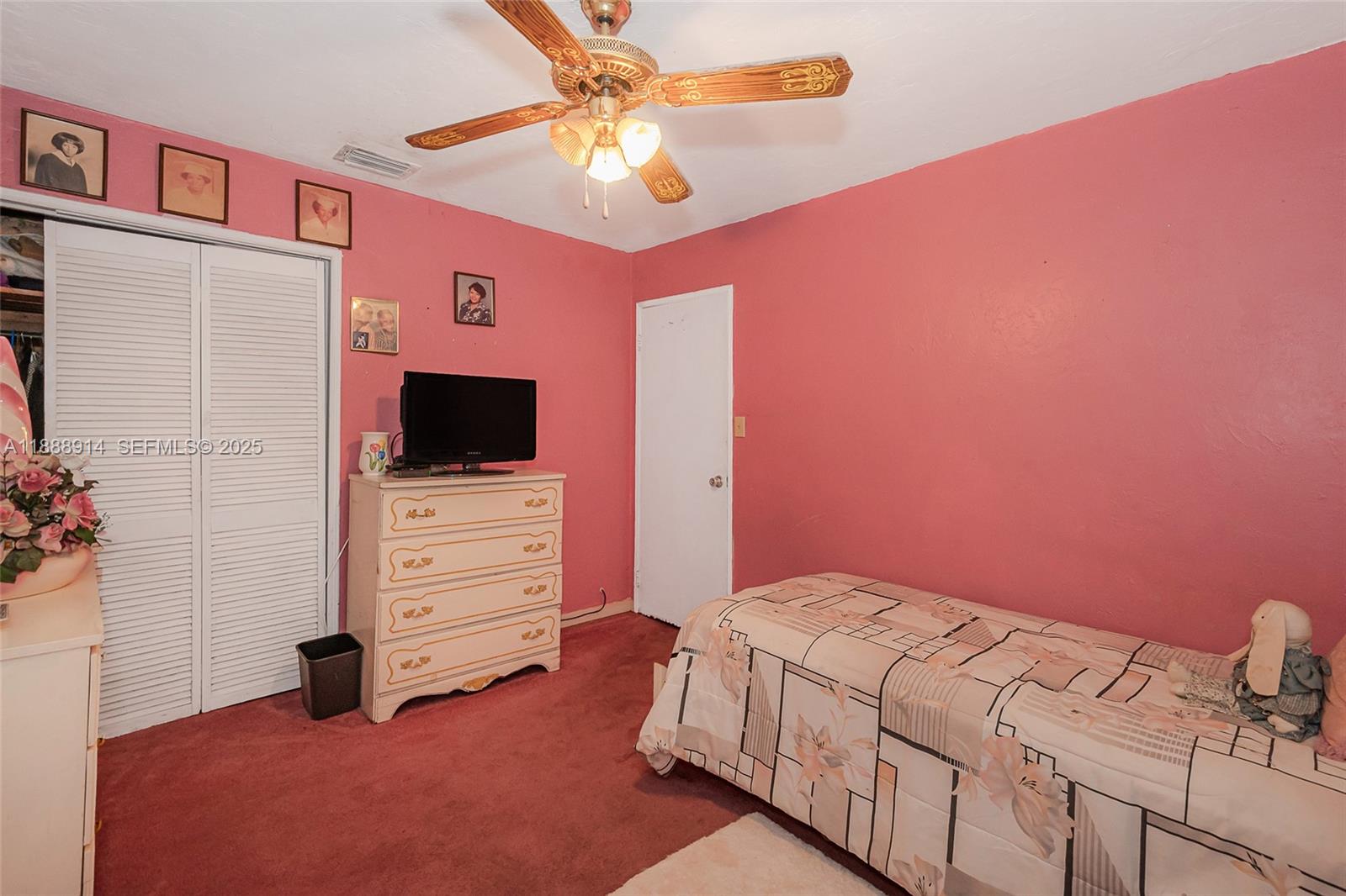 1083 Northwest 74th Street Miami, FL 33150 - Photo 23 of 28 a bedroom with a bed and a flat screen tv
