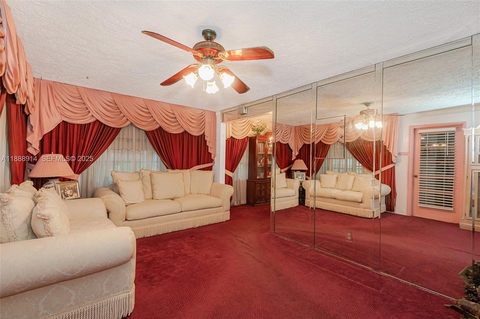 1083 Northwest 74th Street Miami, FL 33150 - Photo 4 of 28 a living room with furniture and a ceiling fan