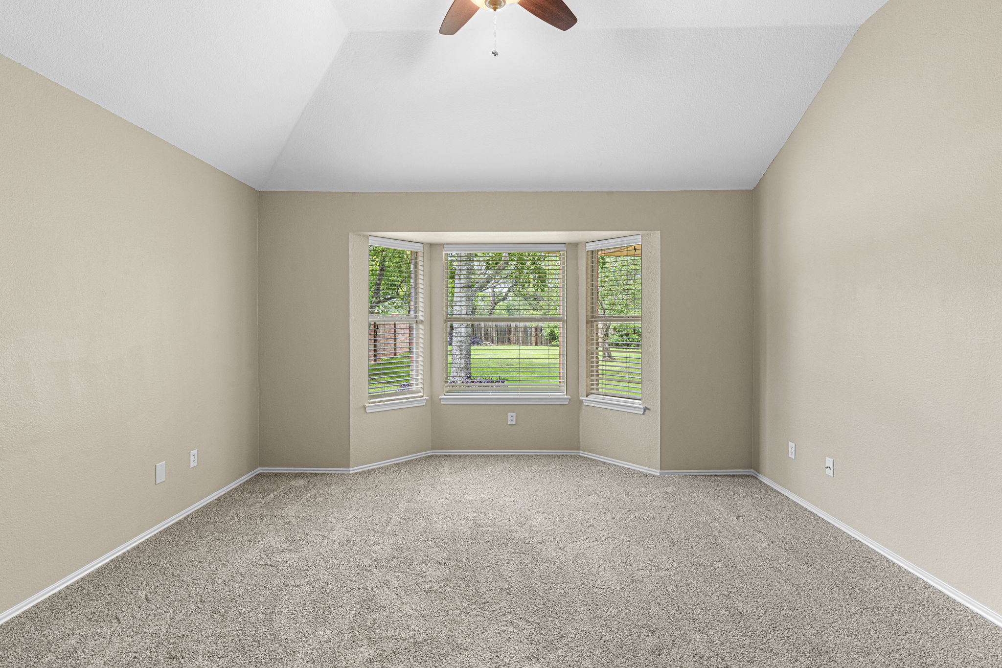 7172 Ridge Oak Road Austin, TX 78749 - Photo 29 of 40 A spacious bedroom features a captivating bay window, offering serene views of the verdant yard.