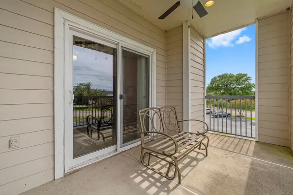 a view of a balcony with furniture