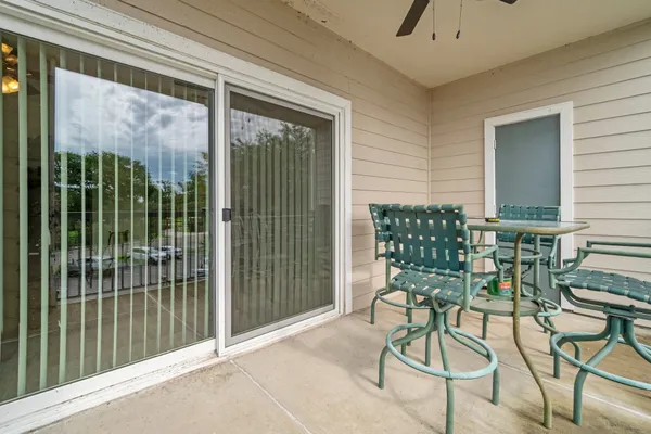a view of a porch with chairs and backyard