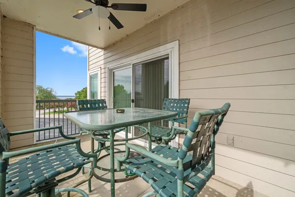 a roof deck with table and chairs