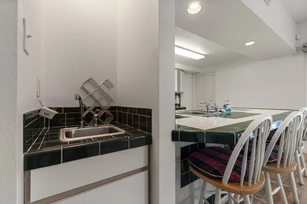 a kitchen with a sink appliances and cabinets