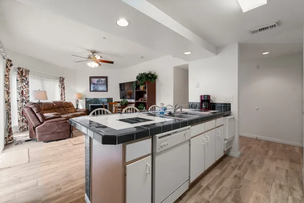 a kitchen with sink stove and refrigerator