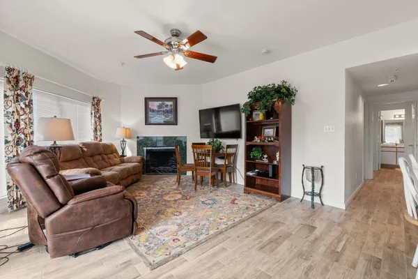 a living room with furniture and a flat screen tv with wooden floor