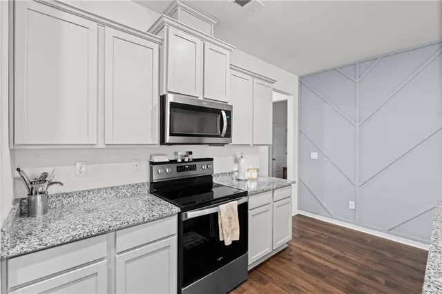 a kitchen with a sink stove and microwave